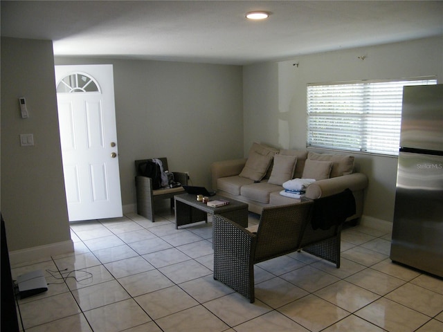 living area with light tile patterned floors and baseboards