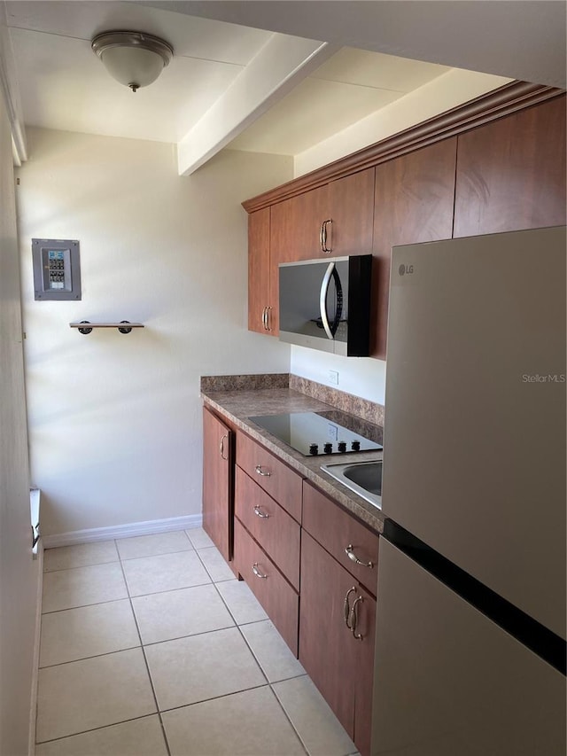 1837 Club Cir Unit 1837, Lakeshore, FL 33854 - kitchen with baseboards, appliances with stainless steel finishes, dark countertops, and light tile patterned floors
