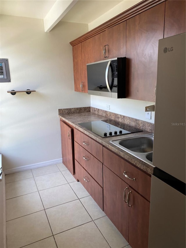 1837 Club Cir Unit 1837, Lakeshore, FL 33854 - kitchen with baseboards, appliances with stainless steel finishes, light tile patterned floors, and dark countertops
