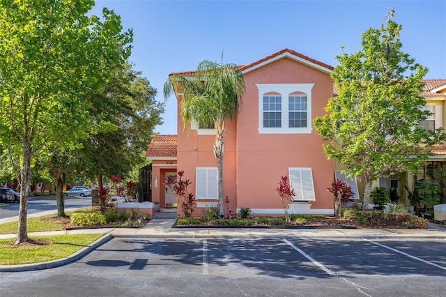 4722 Flagler Beach Way, Kissimmee, FL 34746 - view of front of home with stucco siding, uncovered parking, and a tiled roof