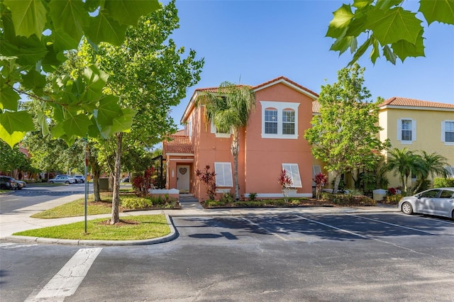 4722 Flagler Beach Way, Kissimmee, FL 34746 - townhome / multi-family property with a tile roof, uncovered parking, and stucco siding