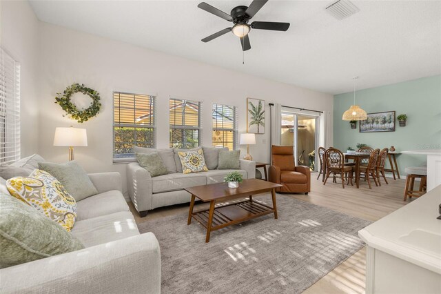 4722 Flagler Beach Way, Kissimmee, FL 34746 - living area with visible vents, a ceiling fan, and light wood-style flooring