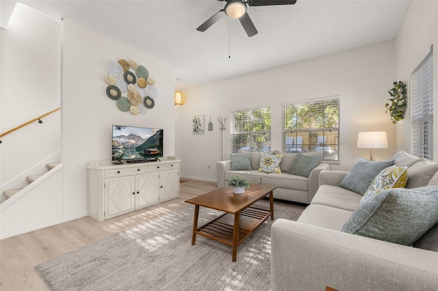 4722 Flagler Beach Way, Kissimmee, FL 34746 - living room with stairway, ceiling fan, light wood-style flooring, and baseboards