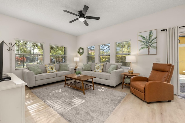 4722 Flagler Beach Way, Kissimmee, FL 34746 - living room with a ceiling fan, a textured ceiling, and light wood finished floors