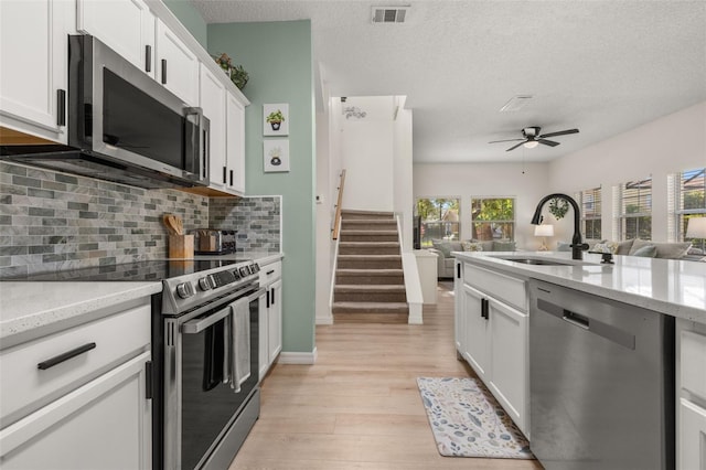 4722 Flagler Beach Way, Kissimmee, FL 34746 - kitchen with stainless steel appliances, backsplash, open floor plan, and a sink