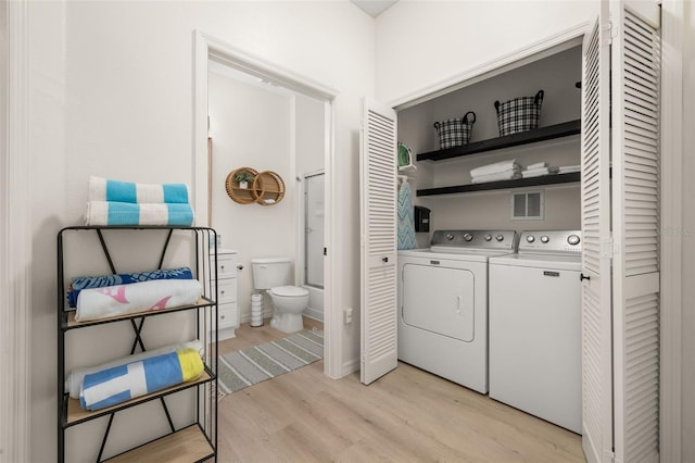 4722 Flagler Beach Way, Kissimmee, FL 34746 - washroom with visible vents, laundry area, light wood finished floors, and independent washer and dryer