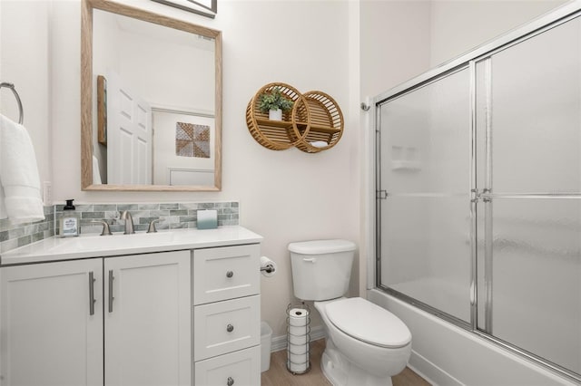 4722 Flagler Beach Way, Kissimmee, FL 34746 - full bath featuring wood finished floors, decorative backsplash, combined bath / shower with glass door, toilet, and vanity