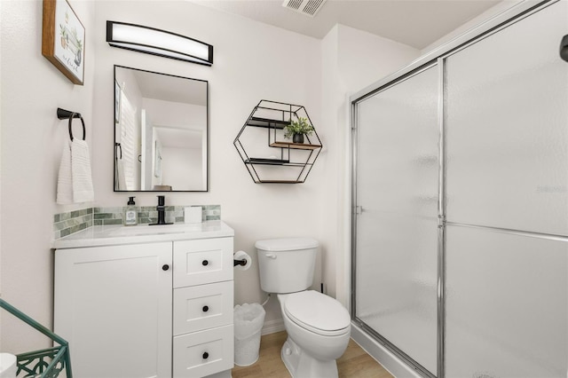 4722 Flagler Beach Way, Kissimmee, FL 34746 - full bath with wood finished floors, toilet, vanity, visible vents, and a stall shower