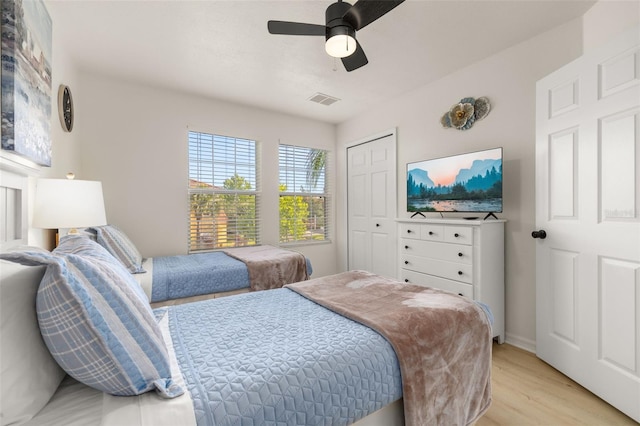 4722 Flagler Beach Way, Kissimmee, FL 34746 - bedroom featuring light wood-style flooring, a closet, baseboards, visible vents, and a ceiling fan