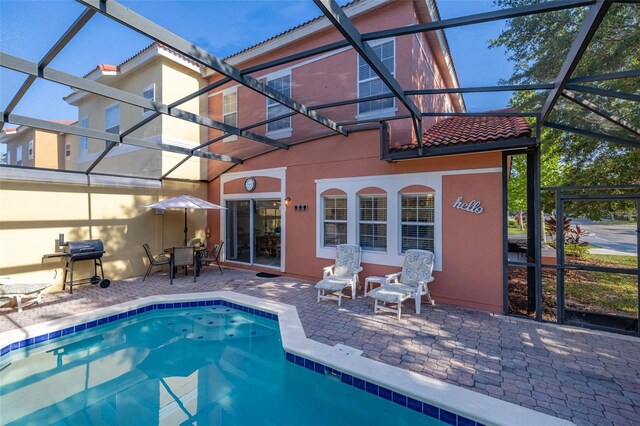 4722 Flagler Beach Way, Kissimmee, FL 34746 - back of property featuring an outdoor pool, stucco siding, a tile roof, and a patio area