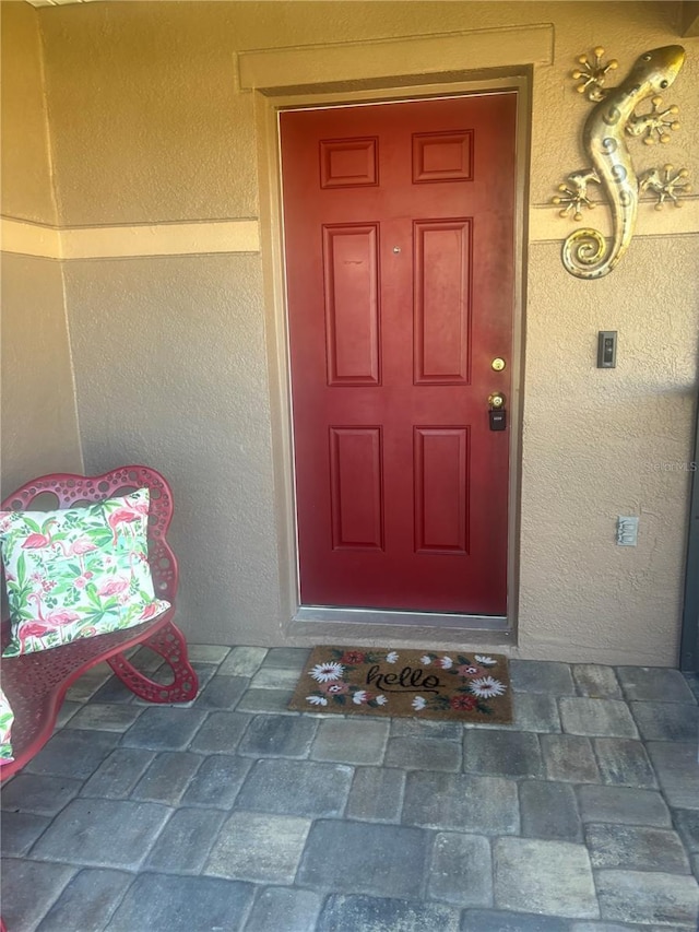 entrance to property with stucco siding