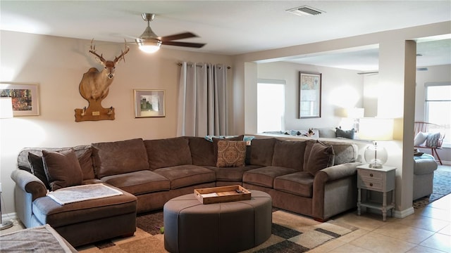 living room with visible vents, ceiling fan, and light tile patterned floors