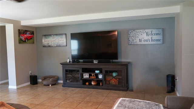 living room featuring tile patterned floors and baseboards