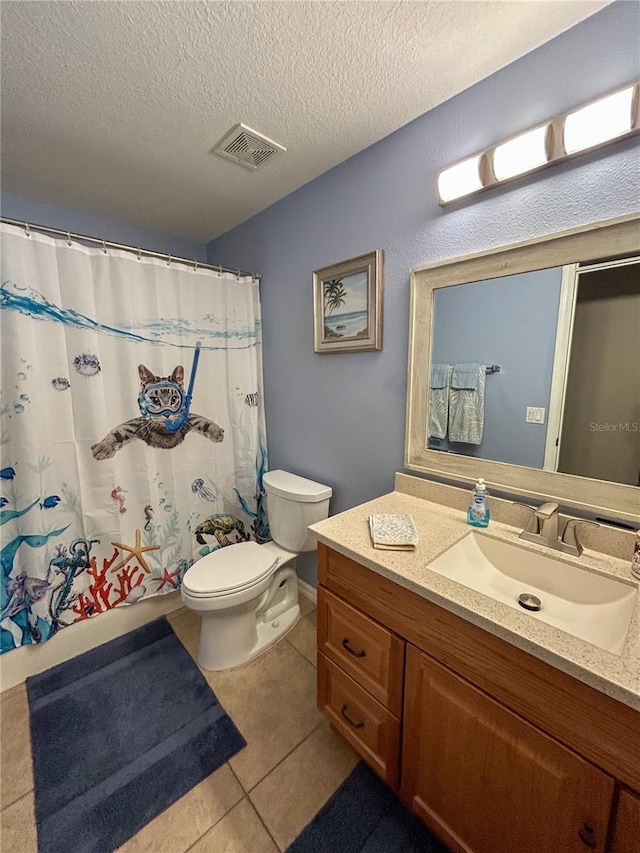 bathroom featuring visible vents, vanity, toilet, a textured ceiling, and tile patterned floors