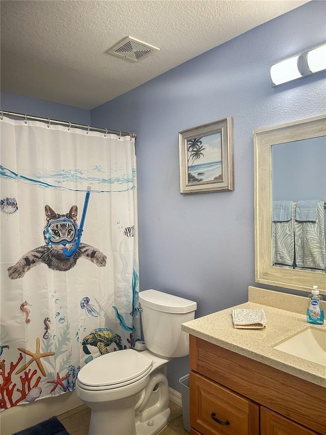 full bath with vanity, toilet, tile patterned floors, a textured ceiling, and visible vents