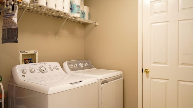 clothes washing area featuring laundry area and washing machine and dryer