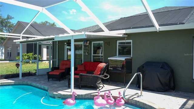 rear view of property featuring a patio, a lanai, an outdoor pool, and stucco siding