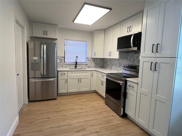 3658 Briarcliff Way, Mims, FL 32754 - kitchen featuring decorative backsplash, a sink, light countertops, light wood-style floors, and stainless steel appliances