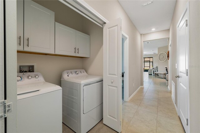 13475 Crest Lake Dr, Hudson, FL 34669 - laundry room featuring recessed lighting, cabinet space, washing machine and clothes dryer, light tile patterned floors, and visible vents
