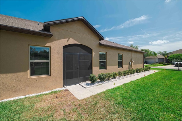 13475 Crest Lake Dr, Hudson, FL 34669 - property entrance featuring a lawn and stucco siding