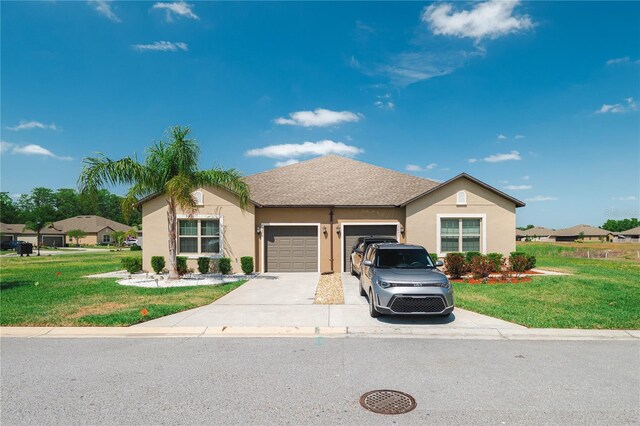 13475 Crest Lake Dr, Hudson, FL 34669 - view of front of property with stucco siding, a front lawn, concrete driveway, and an attached garage