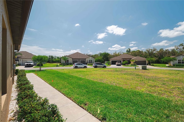 13475 Crest Lake Dr, Hudson, FL 34669 - view of yard featuring a garage and driveway