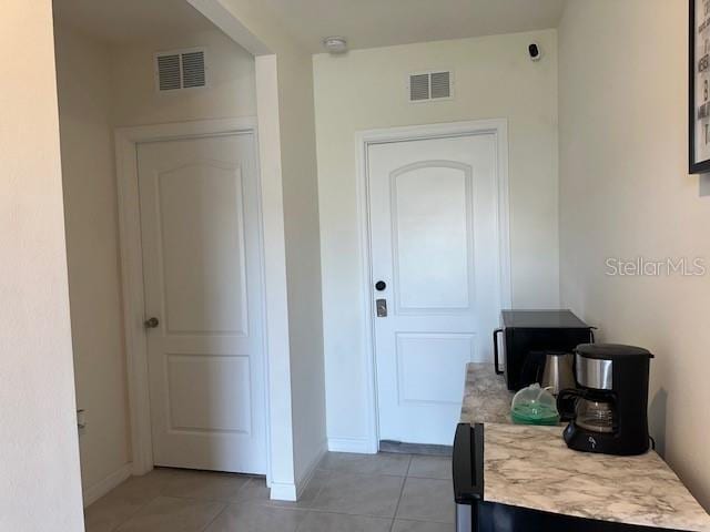 4373 Deleon St, Haines City, FL 33844 - hallway featuring light tile patterned flooring, baseboards, and visible vents