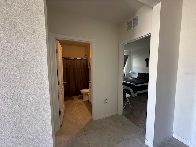 4373 Deleon St, Haines City, FL 33844 - hall with visible vents, baseboards, light tile patterned floors, and light carpet