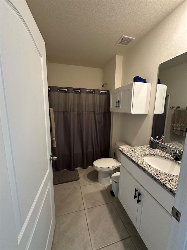 4373 Deleon St, Haines City, FL 33844 - full bath with visible vents, tile patterned flooring, curtained shower, toilet, and a textured ceiling