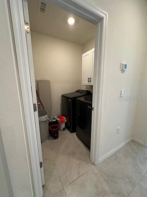 4373 Deleon St, Haines City, FL 33844 - laundry area featuring light tile patterned floors, washing machine and dryer, cabinet space, and visible vents