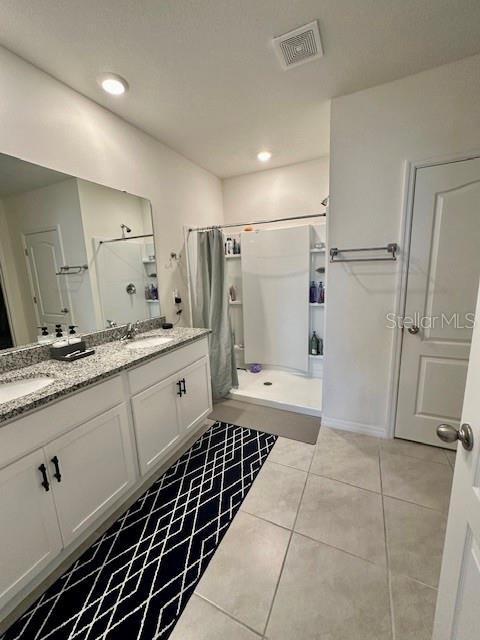 4373 Deleon St, Haines City, FL 33844 - bathroom with a sink, a shower stall, double vanity, and visible vents
