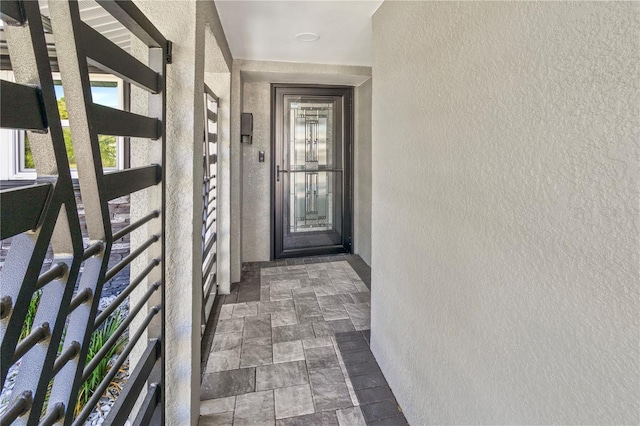 property entrance with stucco siding