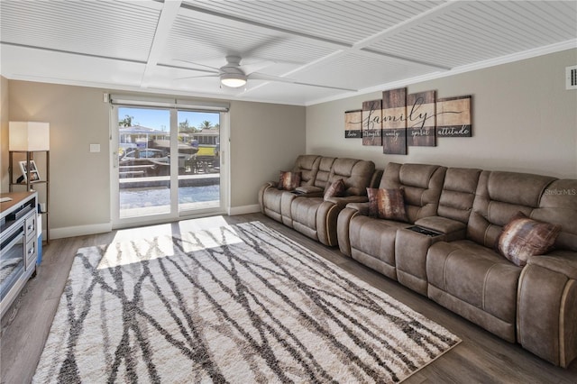 living area with wood finished floors, crown molding, visible vents, baseboards, and ceiling fan