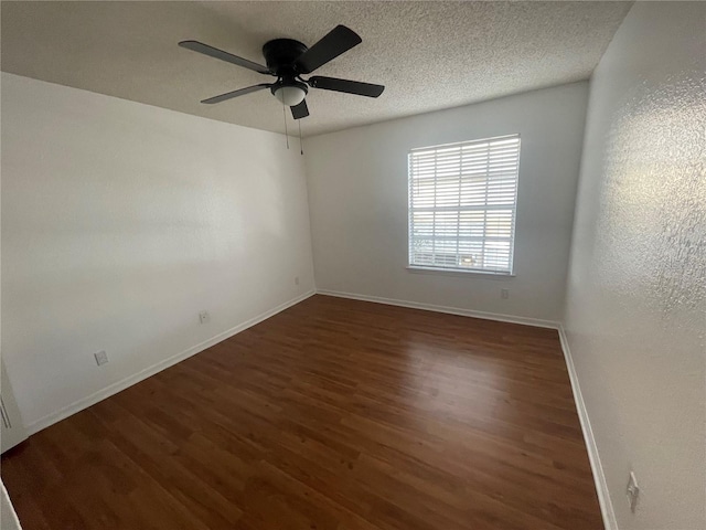 empty room featuring ceiling fan, a textured ceiling, baseboards, and wood finished floors