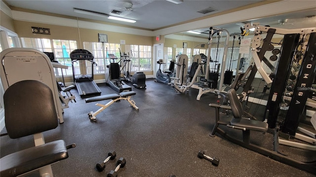 gym with ornamental molding, baseboards, a ceiling fan, and visible vents