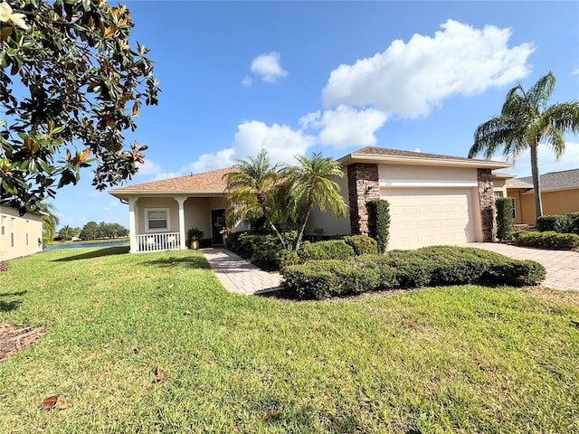 ranch-style home with an attached garage, driveway, a front yard, and stucco siding