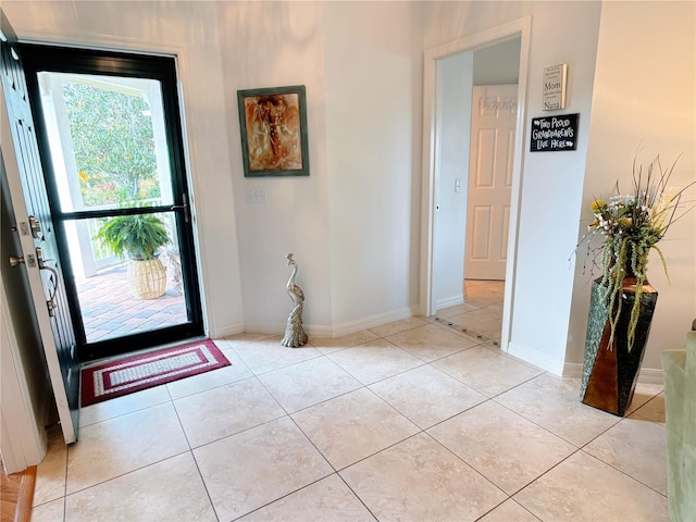 entrance foyer featuring baseboards and light tile patterned floors