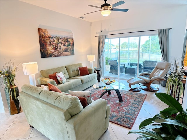 living room featuring light tile patterned flooring, ceiling fan, and visible vents