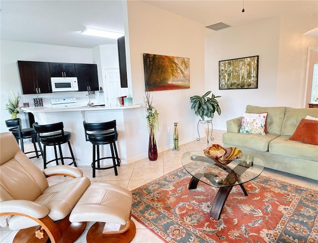 living area featuring visible vents, baseboards, and light tile patterned flooring
