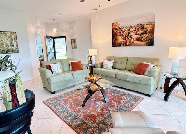 living room with a ceiling fan, light tile patterned flooring, and visible vents