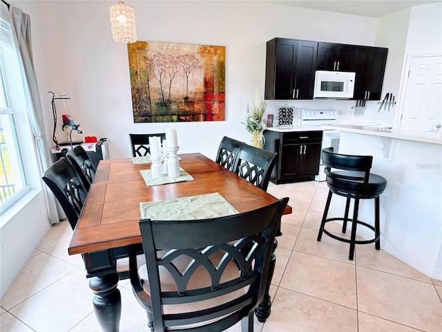 dining room featuring baseboards and light tile patterned flooring