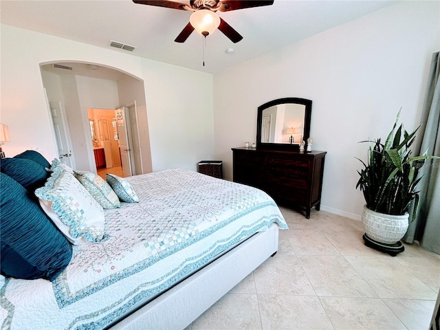 bedroom with arched walkways, a ceiling fan, visible vents, and light tile patterned flooring