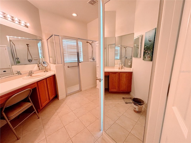 bathroom featuring a sink, tile patterned floors, two vanities, visible vents, and a stall shower