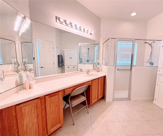 bathroom featuring tile patterned flooring, vanity, and a shower stall