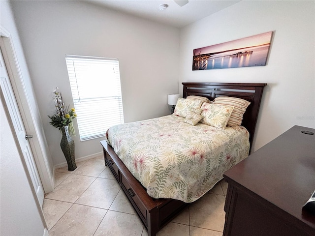 bedroom featuring baseboards and light tile patterned flooring