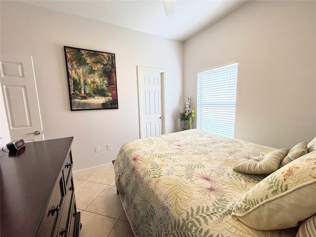bedroom with baseboards, ceiling fan, and light tile patterned floors