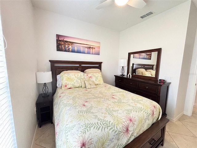 bedroom with visible vents, baseboards, ceiling fan, and light tile patterned flooring