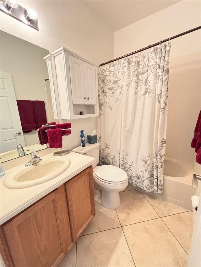 full bath featuring toilet, tile patterned floors, shower / bath combination with curtain, and vanity