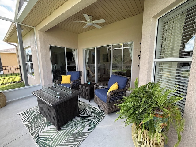 view of patio featuring fence, ceiling fan, and an outdoor living space