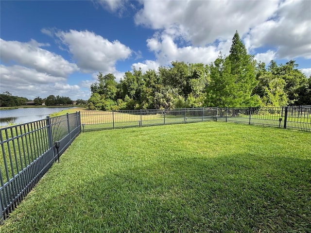 view of yard featuring a fenced backyard and a water view